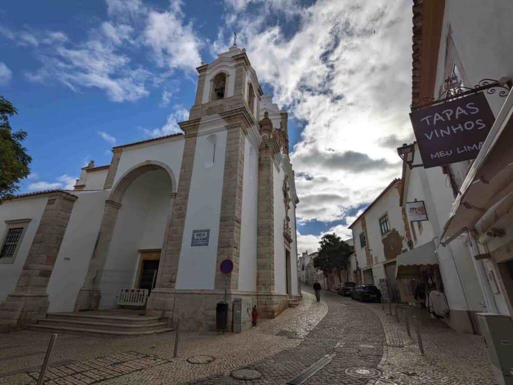 a cobblestone street and church in Lagos, portugal