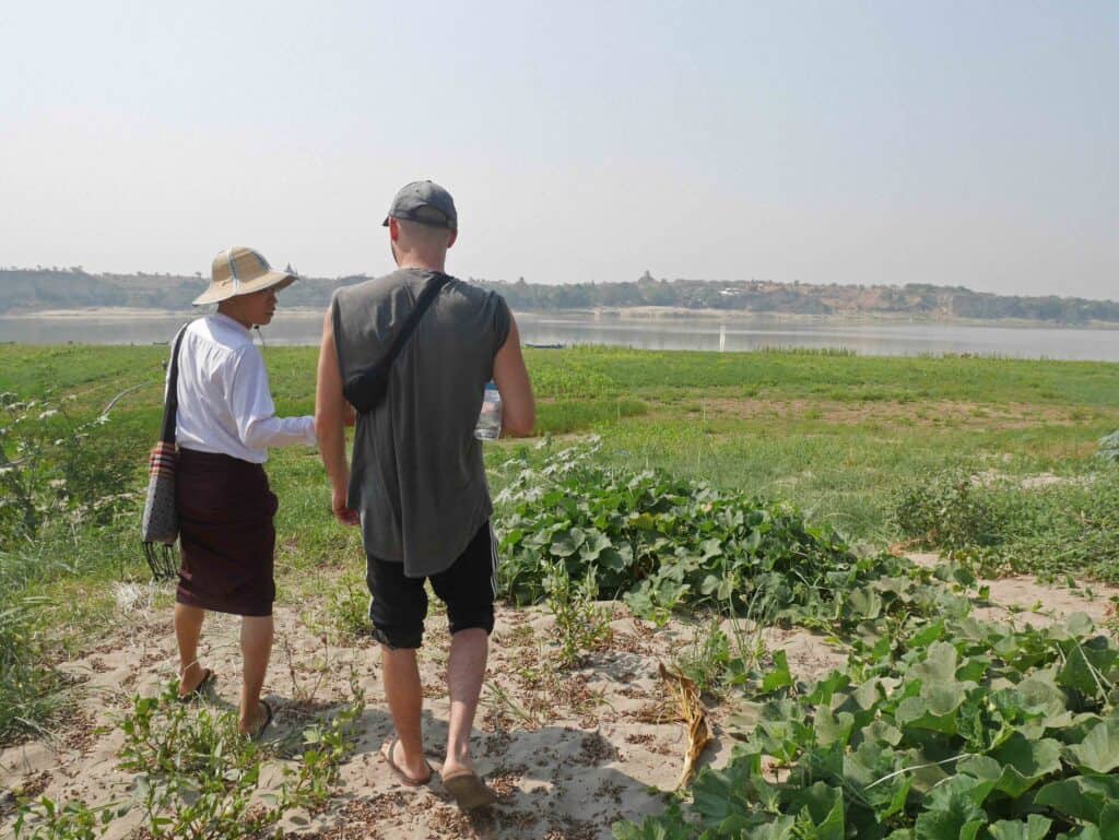 A man talking with a local guide in Bagan, Myanmar about the crops that are grown in the region.