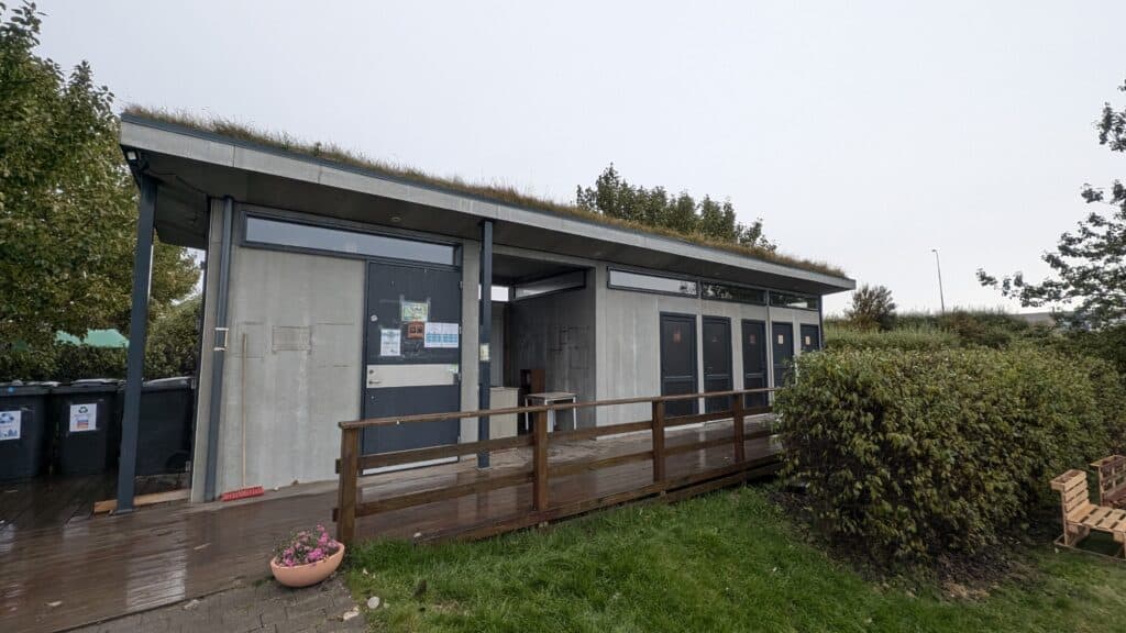 a small building with several doors and an outdoor kitchen