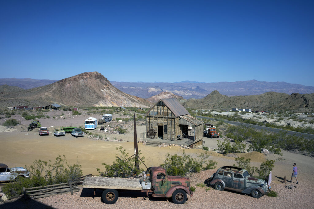 Old structures and vehicles in the desert at Nelson Ghost Town, one of the ghost towns near Las Vegas
