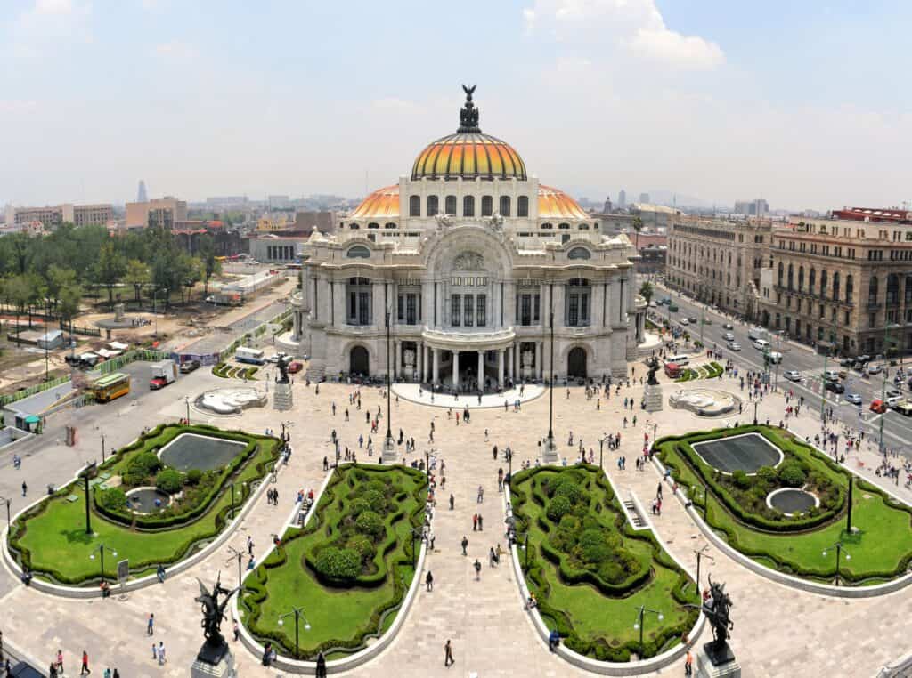 an aerial view of the The Fine Arts Palace Museum, with 4 lush gardens and lots of people walking around