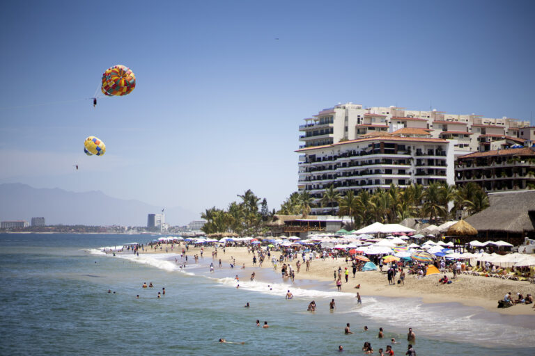 a busy beach in puerto vallarta mexico on a sunny day