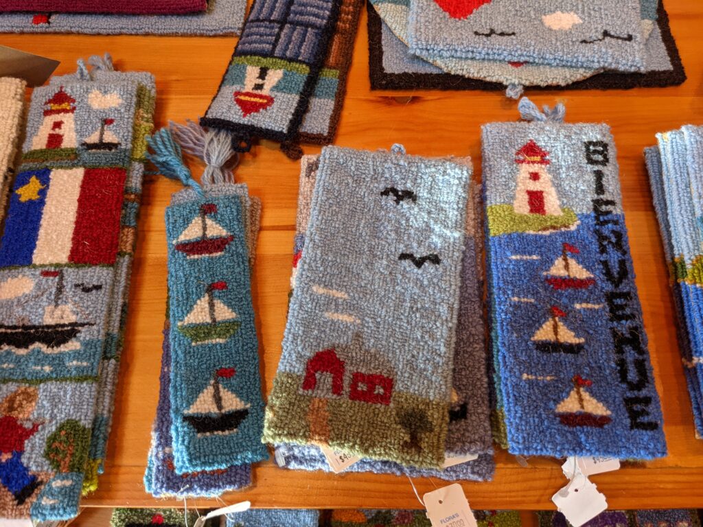colourful small hooked rugs for sale in Cheticamp, Nova Scotia