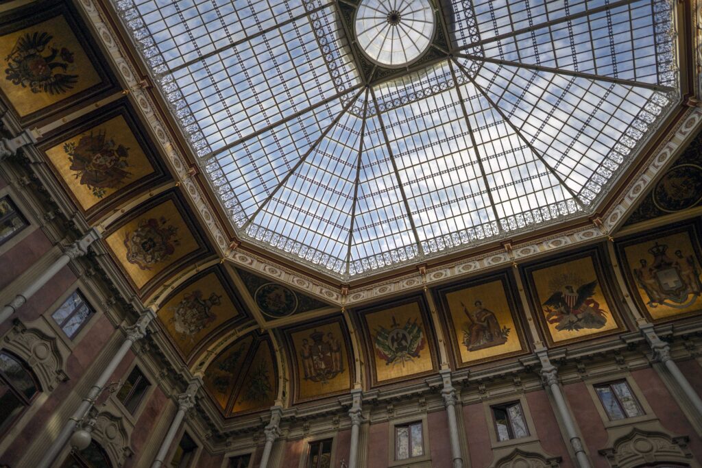 the glass ceiling and paintings on the walls inside Bolsa Palace, Porto