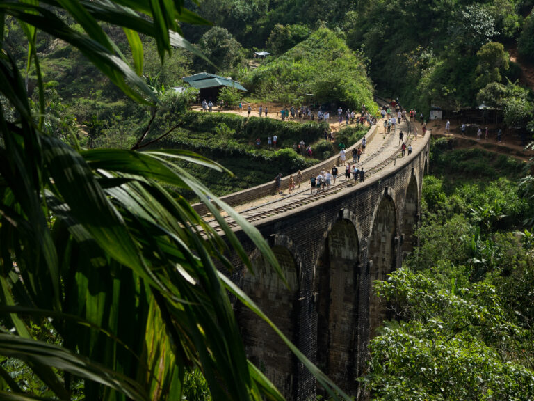 a stone bridge with 9 arches suspended above a valley in sri lanka