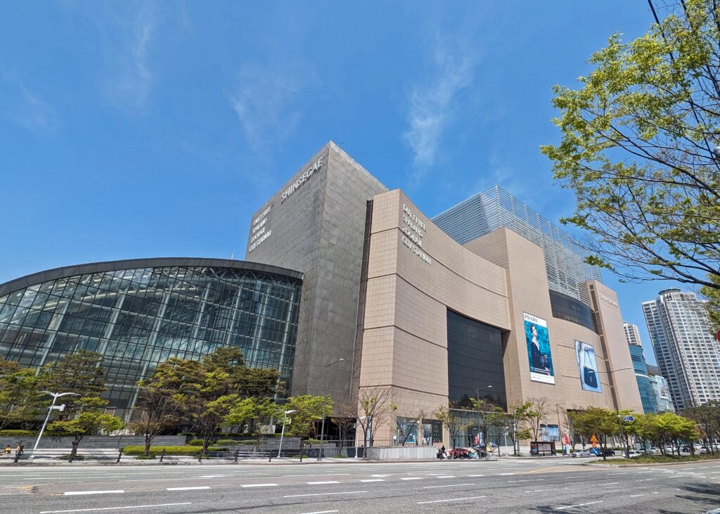 the outside of Shinsegae Department Store in Busan, South Korea on a sunny day