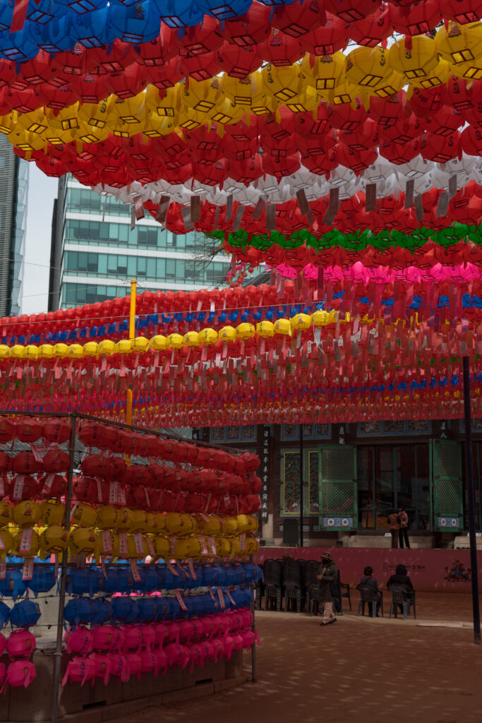 colourful lanterns hanging from above and from the walls at Jogyesa Temple in Seoul, South Korea