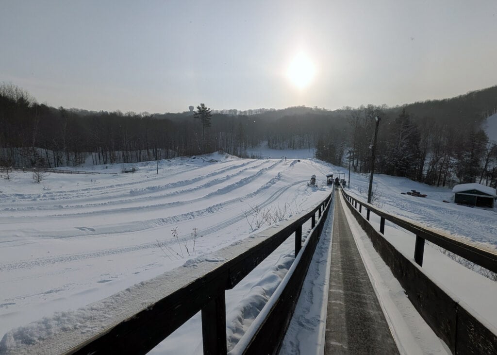 a "magic carpet" stretching up a sloping hill at the snow tubing hill at Horseshoe Valley Resort
