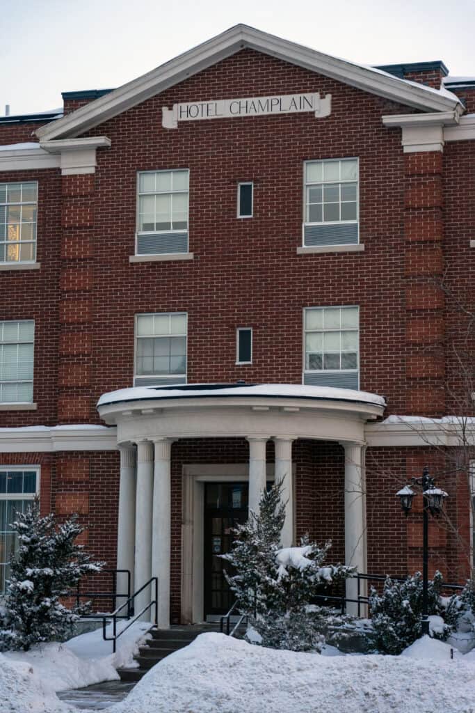 a red-brick historic building with white pillars at the entrance-way, in orillia ontario