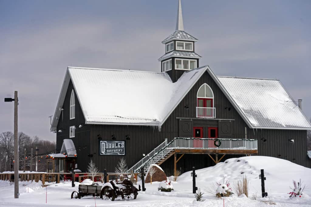 Quayle's Brewery, a blue building that looks like a barn, covered in white snow