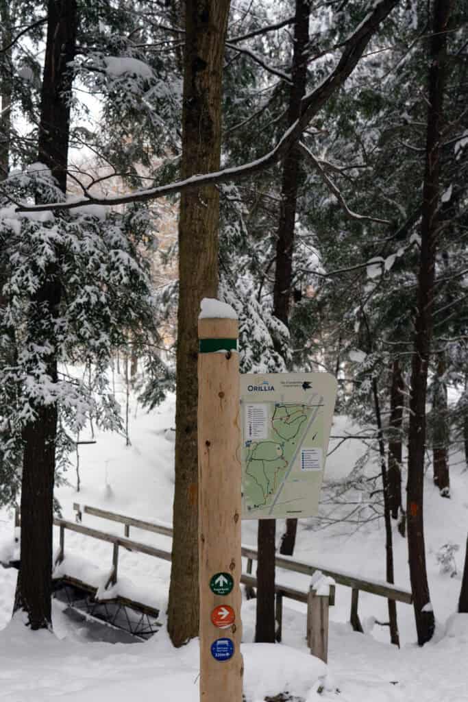 a sign on a wooden post that reads "Orillia" and shows a map of scout valley