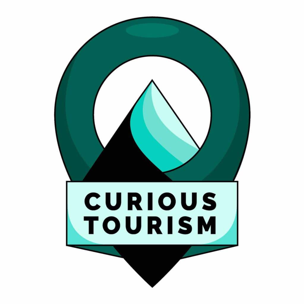 green logo with black text that reads "Curious Tourism"
