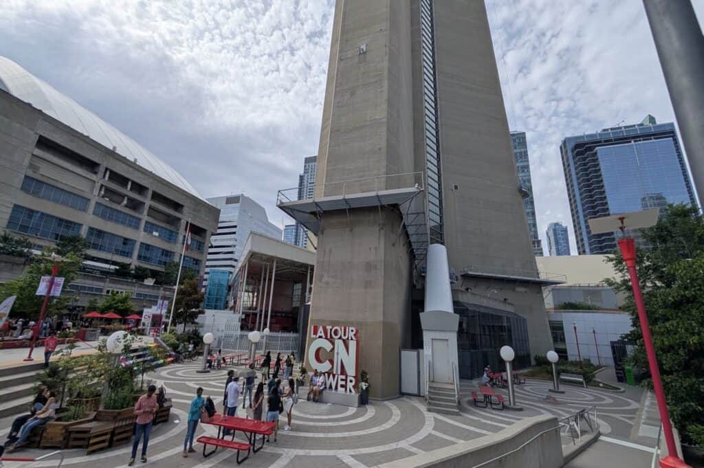 The base of the CN Tower in Toronto, with a large red and white sign that reads "La Tour CN Tower"