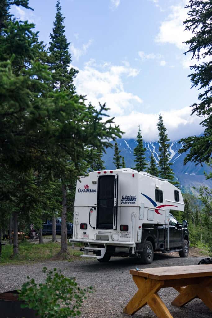 the back of a Canadream RV camper backed into a camping site in Kluane National Park