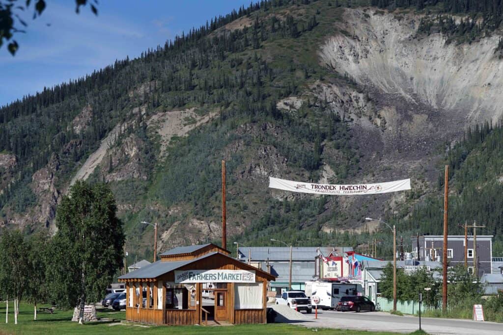 Front Street in Dawson City, with a sign welcoming visitors and a small building that is the farmer's market