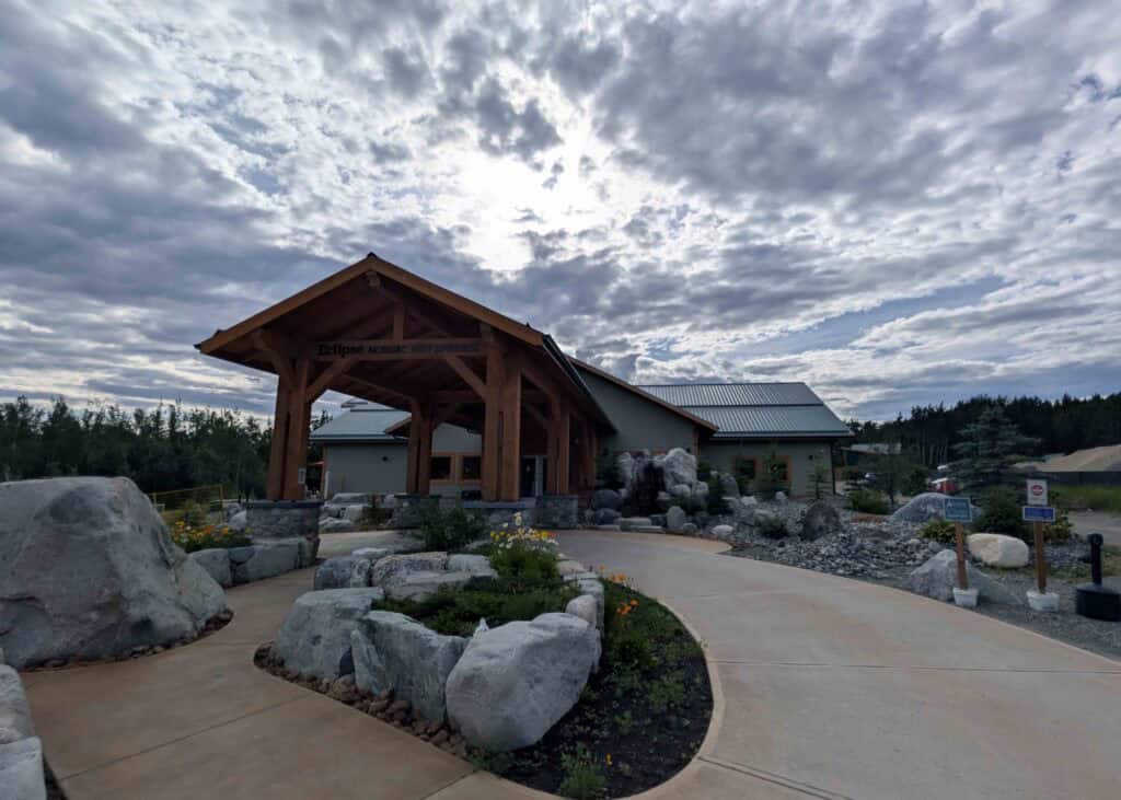 the entrance to a large building, the eclipse takhini hot springs