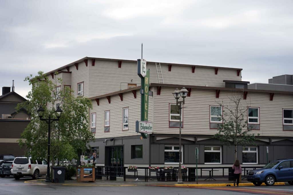 a historic white building with a large sign that reads "edgewater hotel"