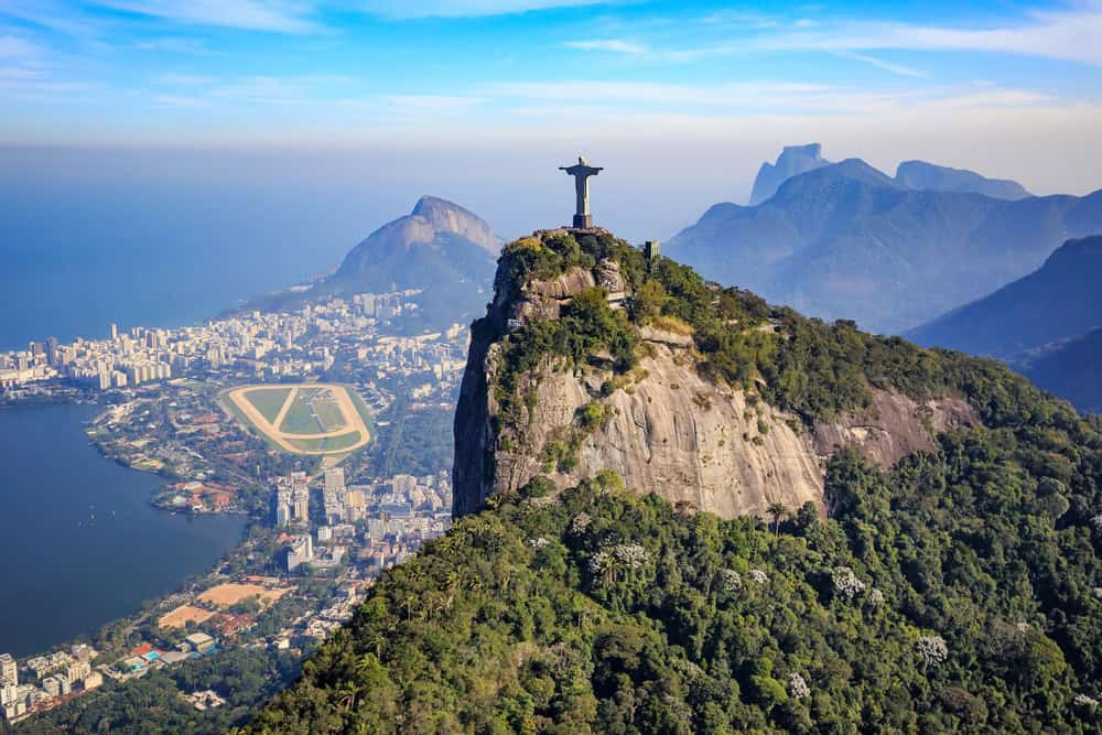 An aerial view Christ The Redeemer, a large monument of christ on top of a mountain which is on the 7 Wonders of the World list.
