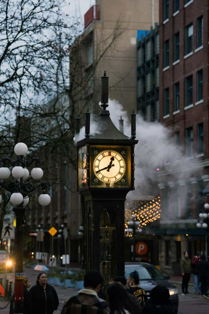 Gastown Steam Clock releasing steam on a city street in Gastown, Vancouver.