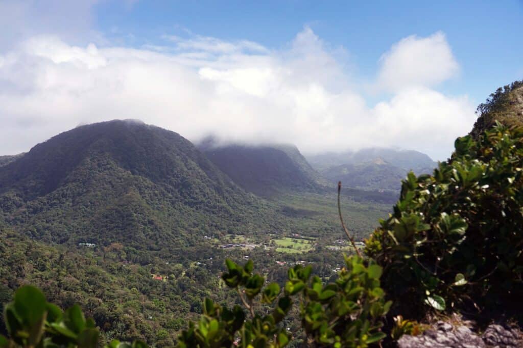 View from La India Dormida ridge overlooking El Valle de Antón crater with forested mountains and low clouds in Panama.