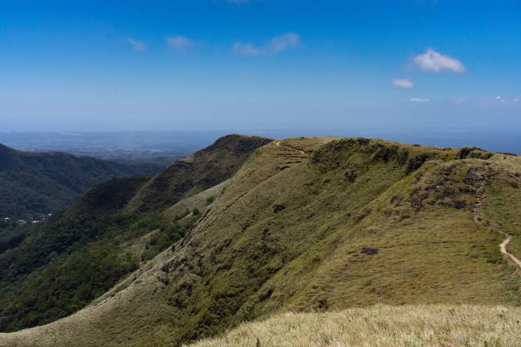 Grassy ridge of La India Dormida with rolling hills and distant mountain views in Panama.