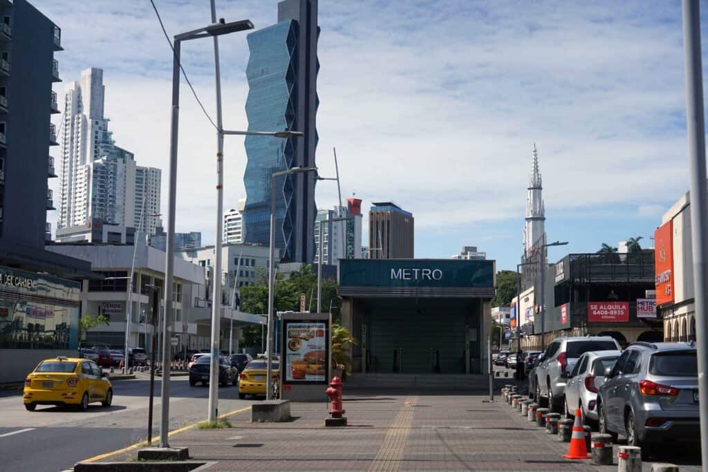 Entrance to Iglesia del Carmen Metro Station in Panama City, surrounded by busy roads and tall buildings