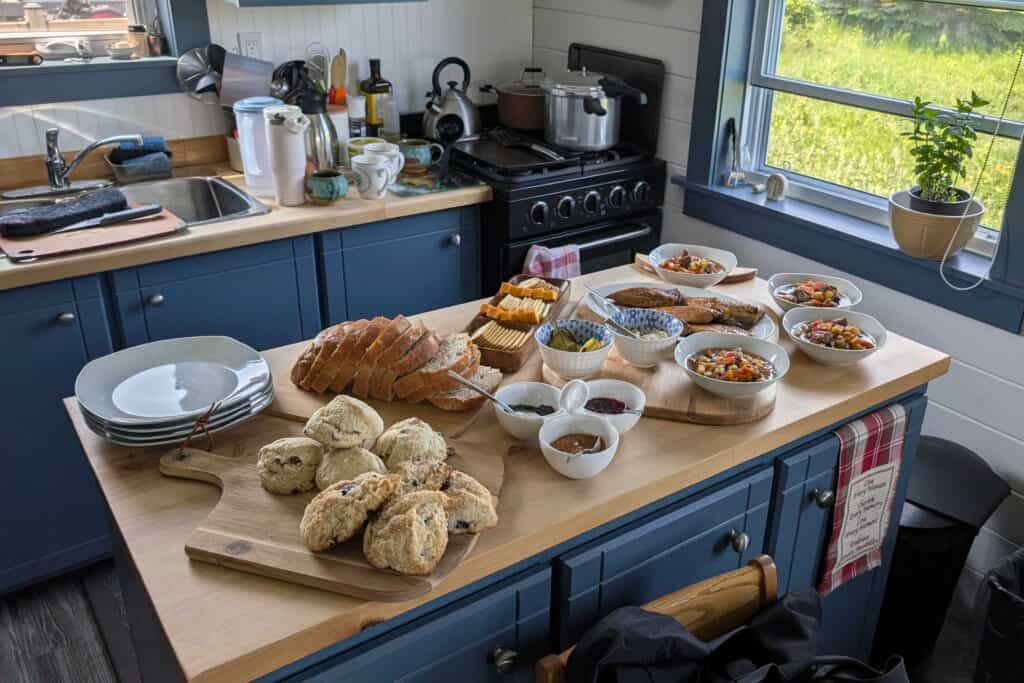 Homemade Newfoundland lunch spread with moose soup, smoked mackerel, fresh bread, scones, local jams, cheese, and coffee prepared in Paul and Joanne's kitchen in the Exploits Islands.