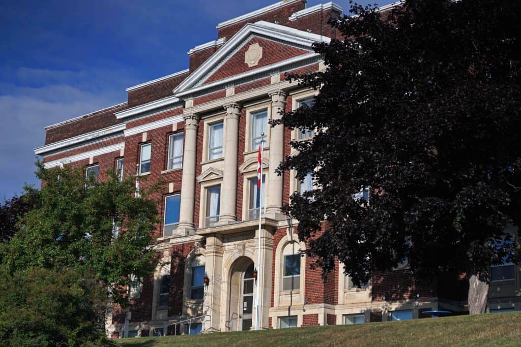 Exterior of The Courthouse Hotel in Thunder Bay, a historic red-brick former courthouse with stone columns.