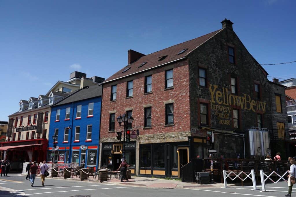 Water Street in downtown St. John’s, Newfoundland and Labrador, with colourful historic buildings, pedestrians and the YellowBelly Brewery and Public House.