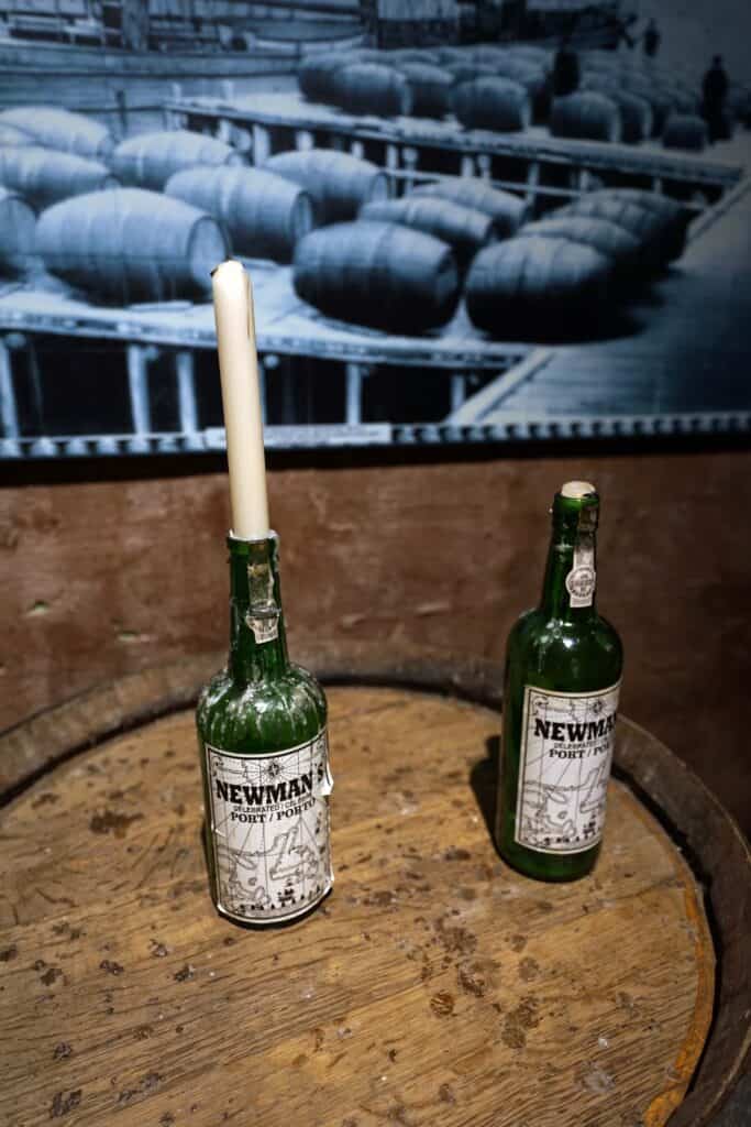 Bottles of Newman’s Celebrated Port displayed on a wooden barrel inside the Newman Wine Vaults in St. John’s.